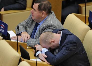 Заместитель председателя комитета Госдумы по делам национальностей Михаил Старшинов (справа) во время заседания подглядывает в шпаргалку на коленях, 2012 год.