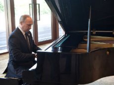Владимир Путин сыграл на рояле мелодии песен о двух российских столицах